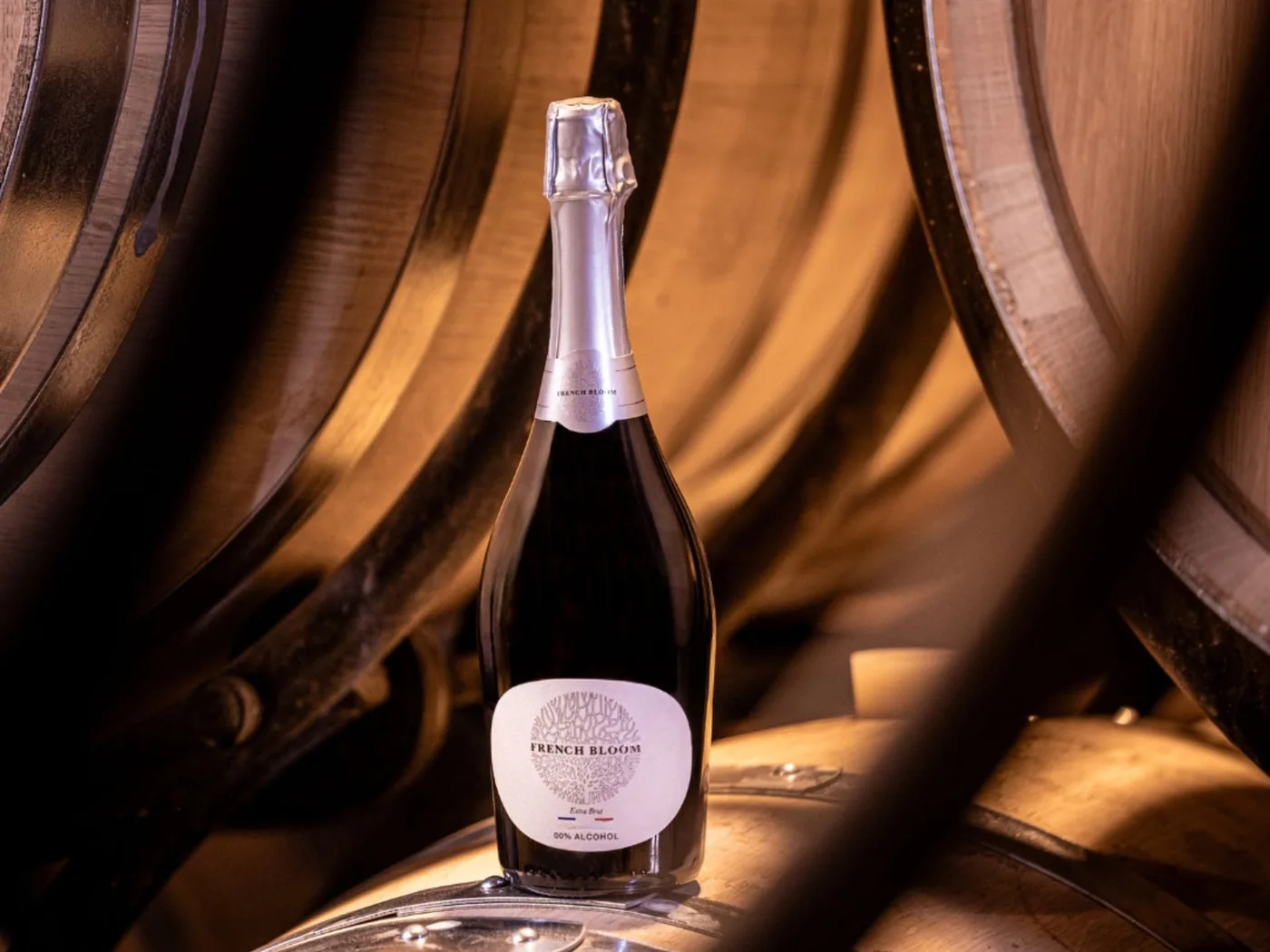 Bouteille French Bloom posée sur des fûts de chêne